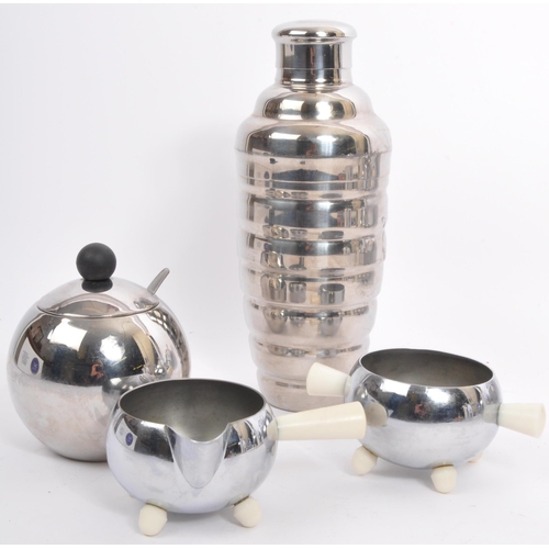 227 - A retro vintage mid 20th Century kitchen wear tea service set. With a white ceramic body with chrome... 