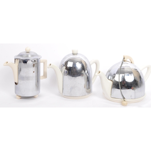 227 - A retro vintage mid 20th Century kitchen wear tea service set. With a white ceramic body with chrome... 