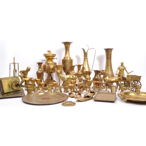 229 - A large collection of 19th century and later brass to include Anglo-Indian incised vases, an oil lam... 