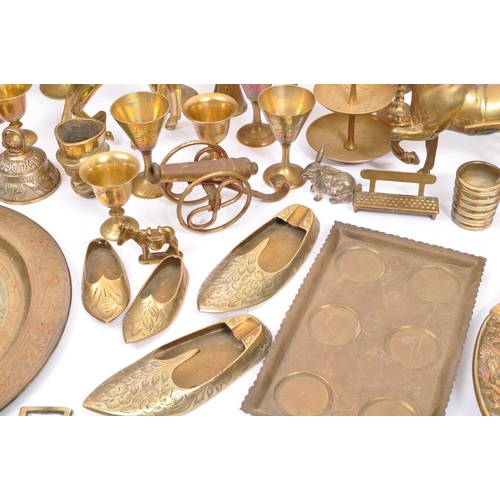 229 - A large collection of 19th century and later brass to include Anglo-Indian incised vases, an oil lam... 