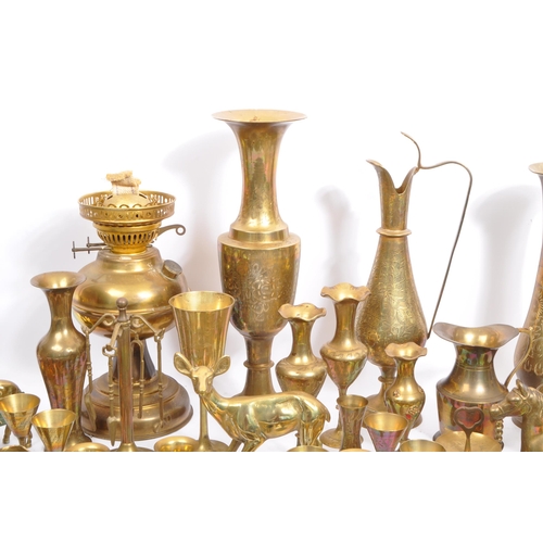 229 - A large collection of 19th century and later brass to include Anglo-Indian incised vases, an oil lam... 