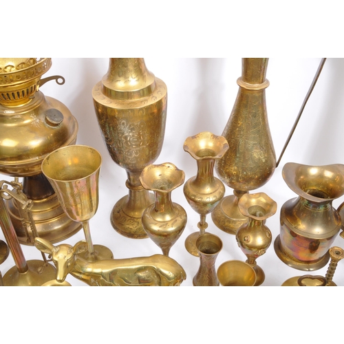 229 - A large collection of 19th century and later brass to include Anglo-Indian incised vases, an oil lam... 