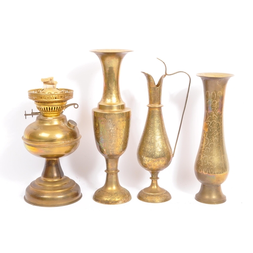 229 - A large collection of 19th century and later brass to include Anglo-Indian incised vases, an oil lam... 