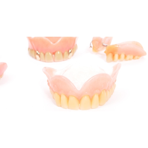 233 - A collection of 20th century false teeth dentures to include examples with gold caps (tests indicate... 