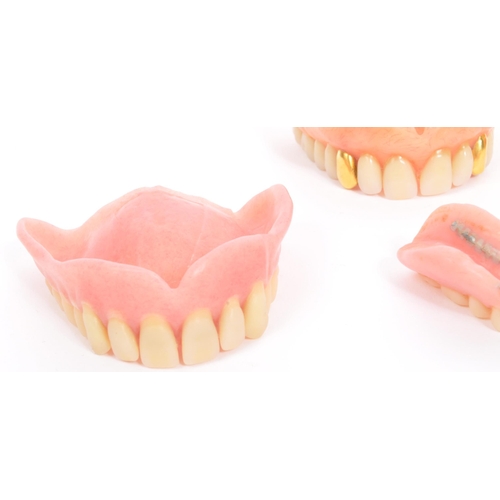 233 - A collection of 20th century false teeth dentures to include examples with gold caps (tests indicate... 