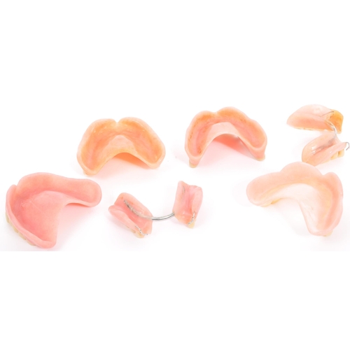 233 - A collection of 20th century false teeth dentures to include examples with gold caps (tests indicate... 