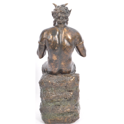 240 - A cast faux bronze classical figurine sculptural ornament in the from of a faun / satyr holding a se... 