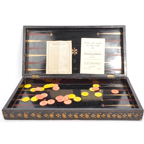 242 - A vintage 19th century folding chessboard/backgammon set. In ebonised wood with gilded detailing aro... 