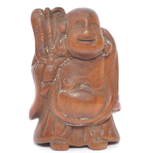 255 - A 20th century Japanese fruitwood buddha netsuke being hand carved and depicted holdingÂ khakkhara. ... 