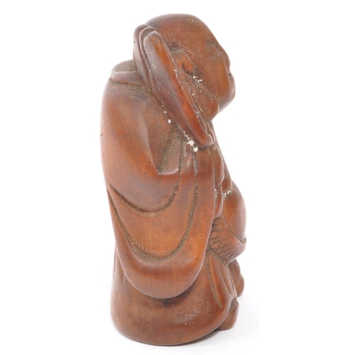 255 - A 20th century Japanese fruitwood buddha netsuke being hand carved and depicted holdingÂ khakkhara. ... 