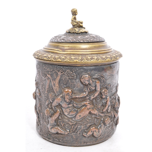 256 - A Victorian late 19th century brass & copper embossed tobacco jar with lid. The jar having top finia... 