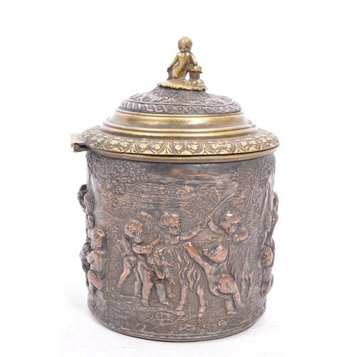 256 - A Victorian late 19th century brass & copper embossed tobacco jar with lid. The jar having top finia... 