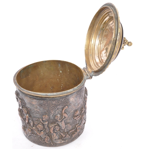 256 - A Victorian late 19th century brass & copper embossed tobacco jar with lid. The jar having top finia... 