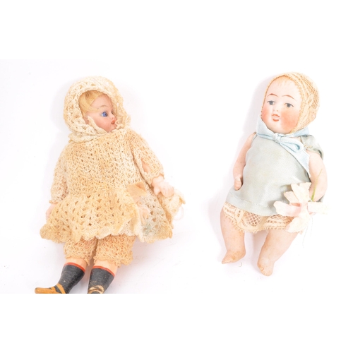 268 - 2 19th century miniature porcelain dolls with lace clothing and bonnets having articulated arms and ... 