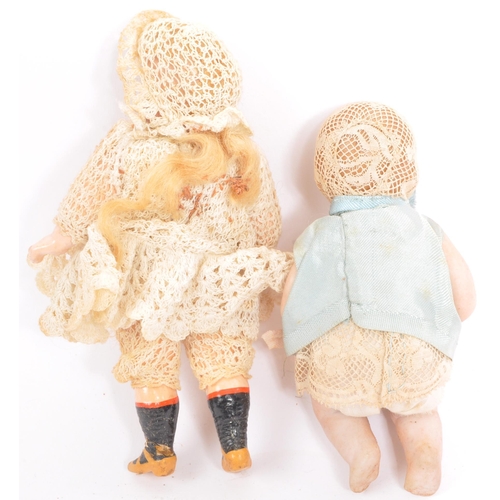 268 - 2 19th century miniature porcelain dolls with lace clothing and bonnets having articulated arms and ... 