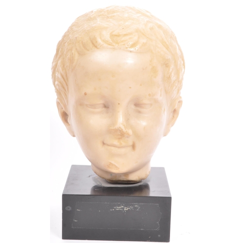 292 - A 20th century resin bust modelled in the form of a young boy raised upon square black marble base.