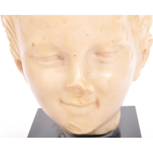 292 - A 20th century resin bust modelled in the form of a young boy raised upon square black marble base.