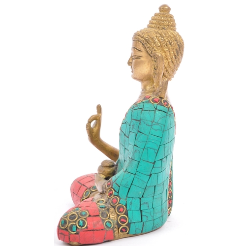 293 - A 20th century brass Indian Buddha ornament depicted inÂ Abhaya Mudra and being set with faux turquo... 