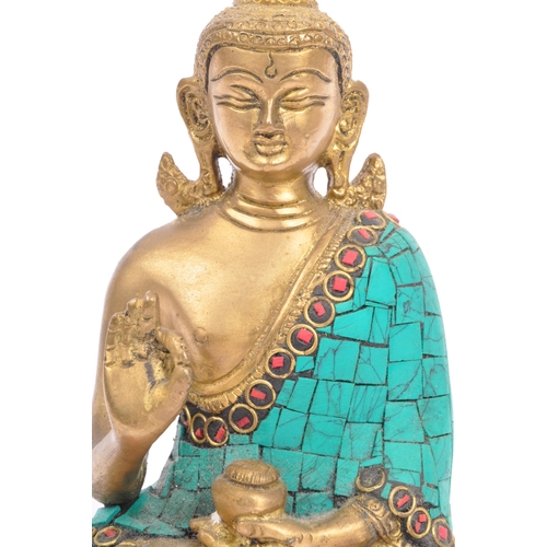 293 - A 20th century brass Indian Buddha ornament depicted inÂ Abhaya Mudra and being set with faux turquo... 