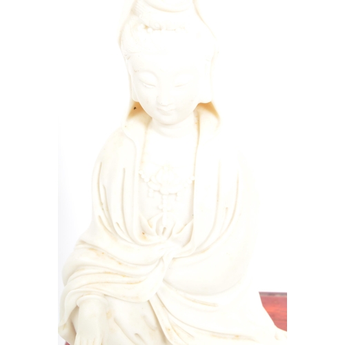 295 - A 20th century Chinese bisque porcelain female GuanyinÂ Bodhisattva figure upon a Chinese pierced so... 