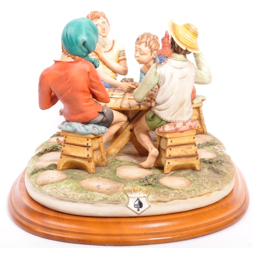 30 - A large Capodimonte group 'The Cheaters', by Bruno Merli, depicting four boys playing cards, on stai... 