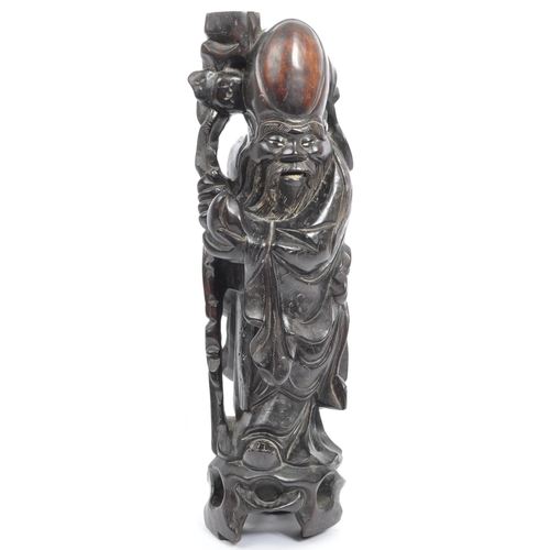 303 - A 19th century Chinese figure, hand carved in the form of immortalÂ Shouxing. The figure having inla... 