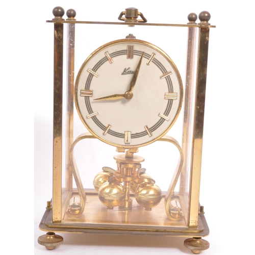 308 - A pair of vintage 20th century anniversary clocks to include a German example in glazed square case ... 