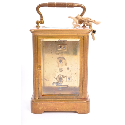 310 - A large early 20th century brass carriage clock. The clock having white enamelled face marked for Ma... 