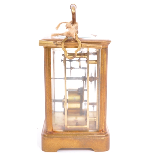 310 - A large early 20th century brass carriage clock. The clock having white enamelled face marked for Ma... 