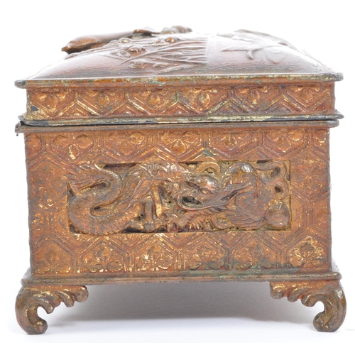 311 - An early 20th century circa. 1920's gilt metal cigarette box. The casket having repousse and relief ... 