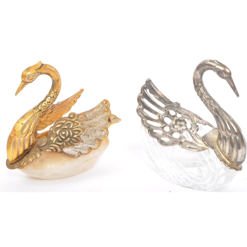 315 - An assortment of 19th century and later curios to include a pair of glass swan salts with one having... 