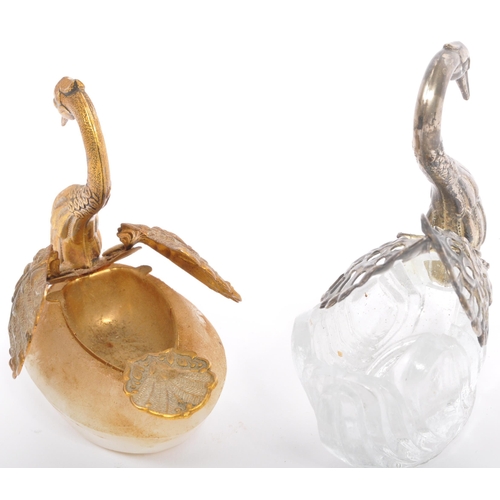 315 - An assortment of 19th century and later curios to include a pair of glass swan salts with one having... 