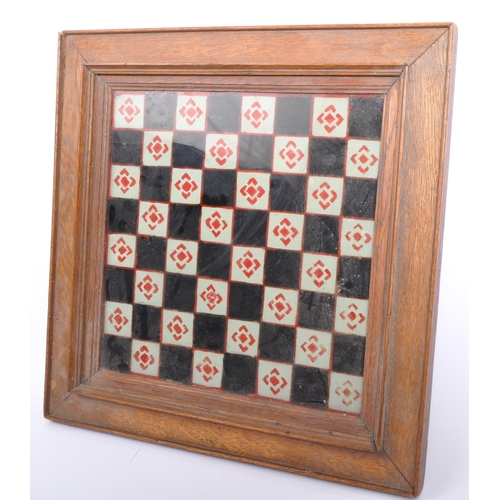 319 - An early 20th century hand painted chess board set within bevelled glass and wooden frame.