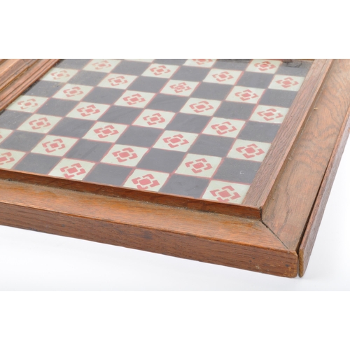 319 - An early 20th century hand painted chess board set within bevelled glass and wooden frame.