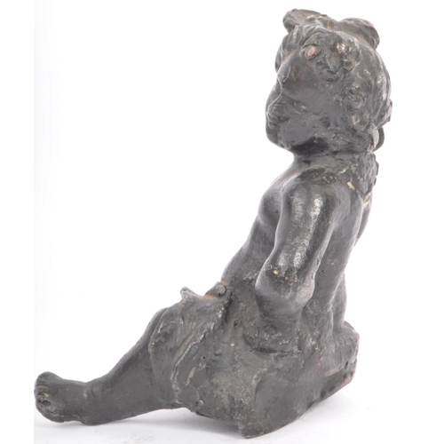 330 - An early 20th lead sculpture in the form of a putti robed and seated with arm raised. Measures 15cm ... 