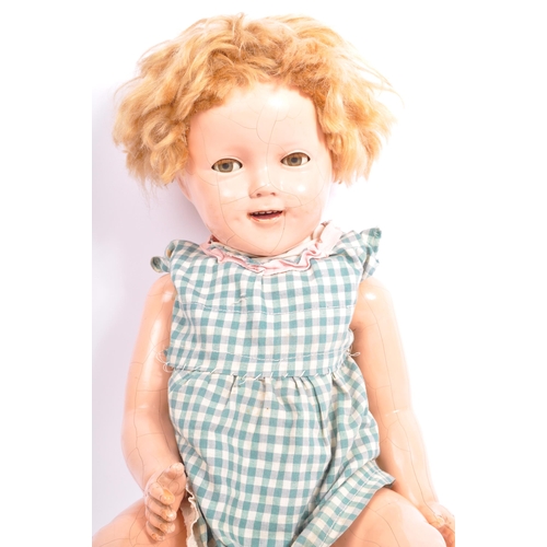 334 - A vintage Shirley Temple composition doll with flirty eyes, open mouth with teeth present, jointed l... 