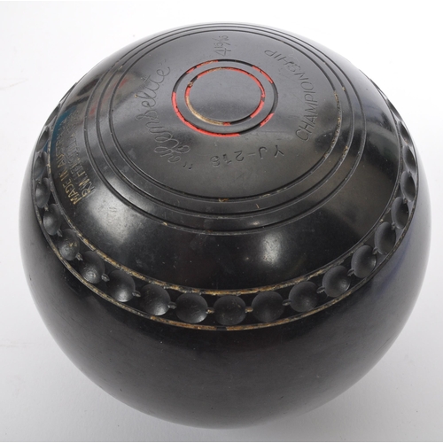 335 - A set of four Australian Henselite garden lawn bowls. Medium weight super grip championship model bo... 