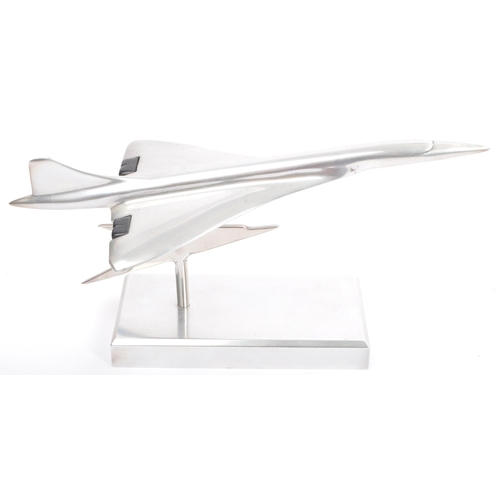 342 - An apprentice piece polished and brushed steel model of Concorde set over plinth with emblem to colu... 