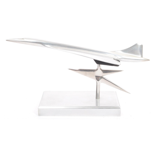 342 - An apprentice piece polished and brushed steel model of Concorde set over plinth with emblem to colu... 