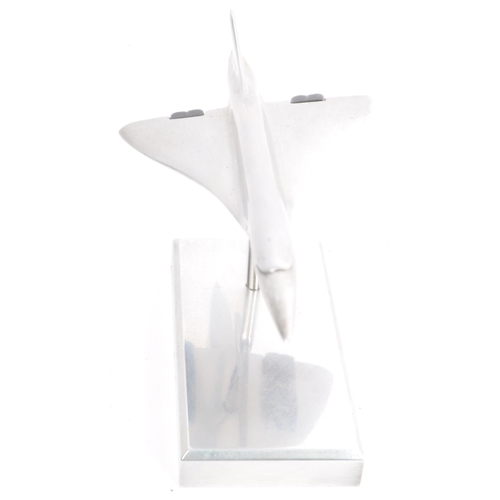 342 - An apprentice piece polished and brushed steel model of Concorde set over plinth with emblem to colu... 