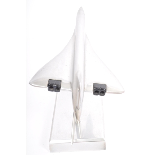 342 - An apprentice piece polished and brushed steel model of Concorde set over plinth with emblem to colu... 