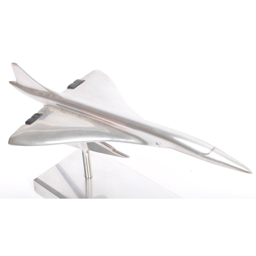 342 - An apprentice piece polished and brushed steel model of Concorde set over plinth with emblem to colu... 