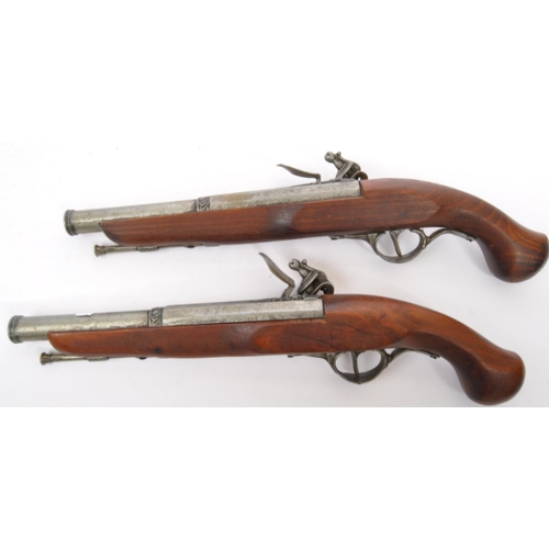 350 - A pair of replica reproduction flintlock wall mountable decorative 18th century pistols. Of wood and... 