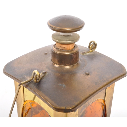 356 - An Arts & Craft brass lantern drinking decanter music box. With stopper and pourer to top, square fo... 