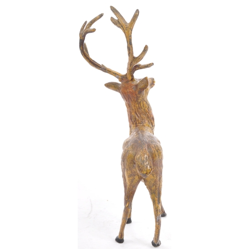 358 - A vintage 20th century statue figure of a stag. In a standing position with black hoofs and antlers.... 