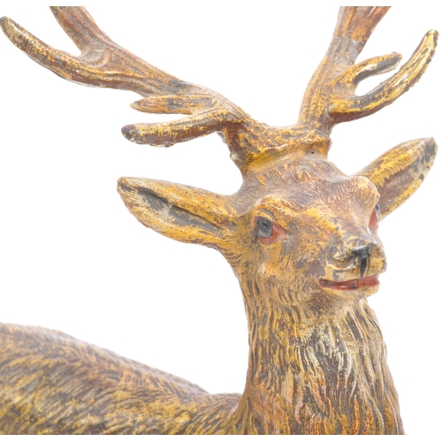 358 - A vintage 20th century statue figure of a stag. In a standing position with black hoofs and antlers.... 