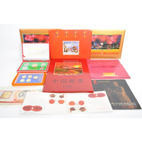 544 - A collection of Oriental / Hong Kong related coins and stamps comprising; x2 1997 Hong Kong handover... 