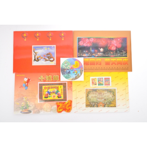 544 - A collection of Oriental / Hong Kong related coins and stamps comprising; x2 1997 Hong Kong handover... 