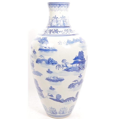 67 - A vintage 20th century Chinese Oriental ceramic blue & white planter vase having a baluster shape wi... 