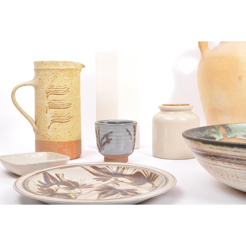 68 - A collection of vintage 20th century studio art pottery items. Including; twin handled vase, mugs, c... 